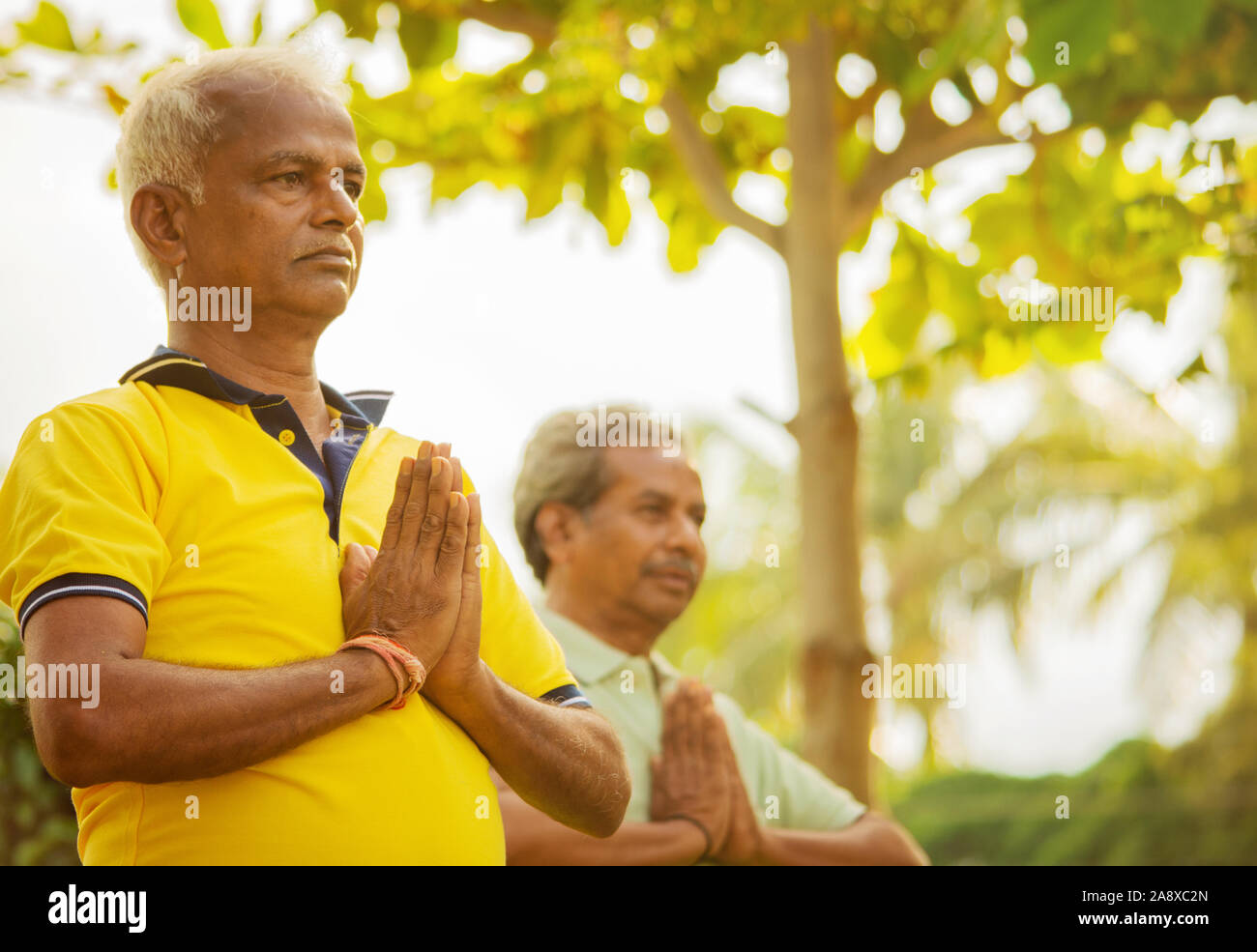 Selektiver Fokus auf Händen ältere Männer üben einfache Yoga - Fitness, Sport, Yoga und gesunden Lebensstil Konzept - zwei ältere Männer mit Namaste Haltung Stockfoto