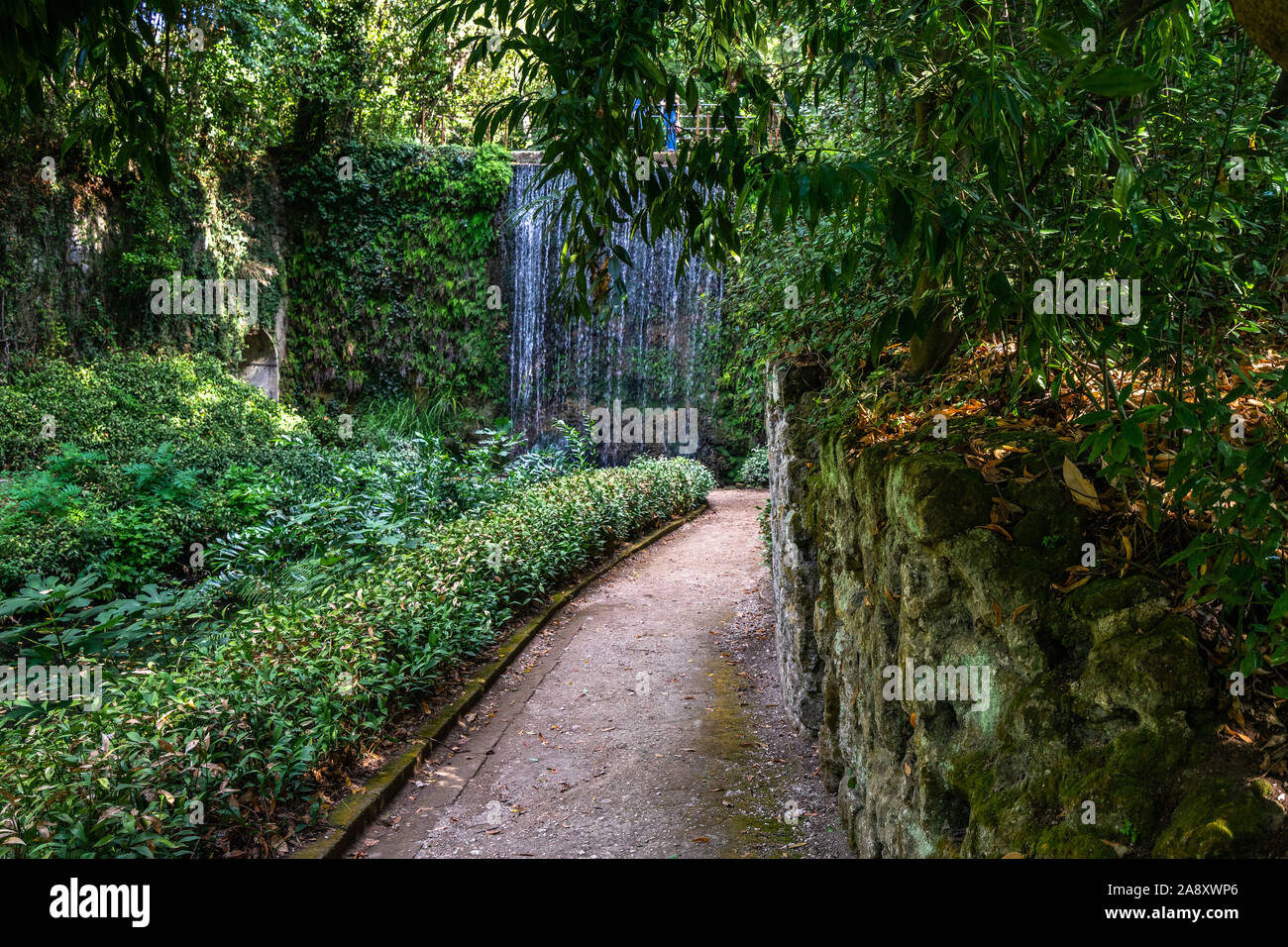 Ein idyllischer Weg, der zu einem kleinen Wasserfall in den Englischen Garten, der Königspalast von Caserta, Kampanien, Italien, Kampanien, Italien Stockfoto