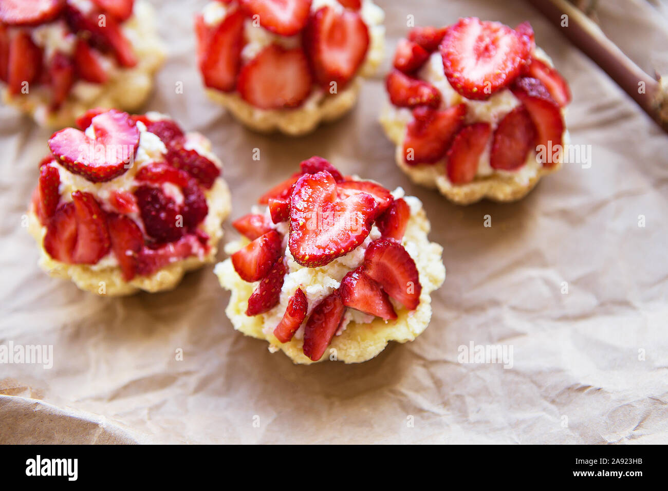 Sehr lecker Muffins mit frischen Erdbeeren liegen auf Kraftpapier. Stockfoto