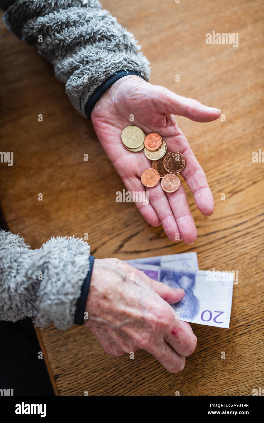 Hände, die Euro-Banknoten und -Münzen Stockfoto