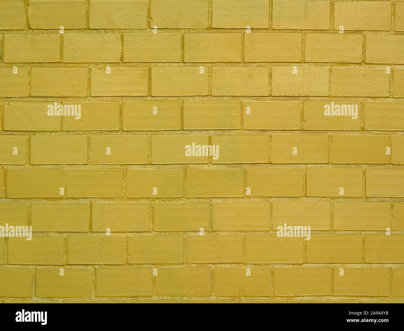Brick Wall in goldener Farbe als Hintergrund gemalt Stockfoto
