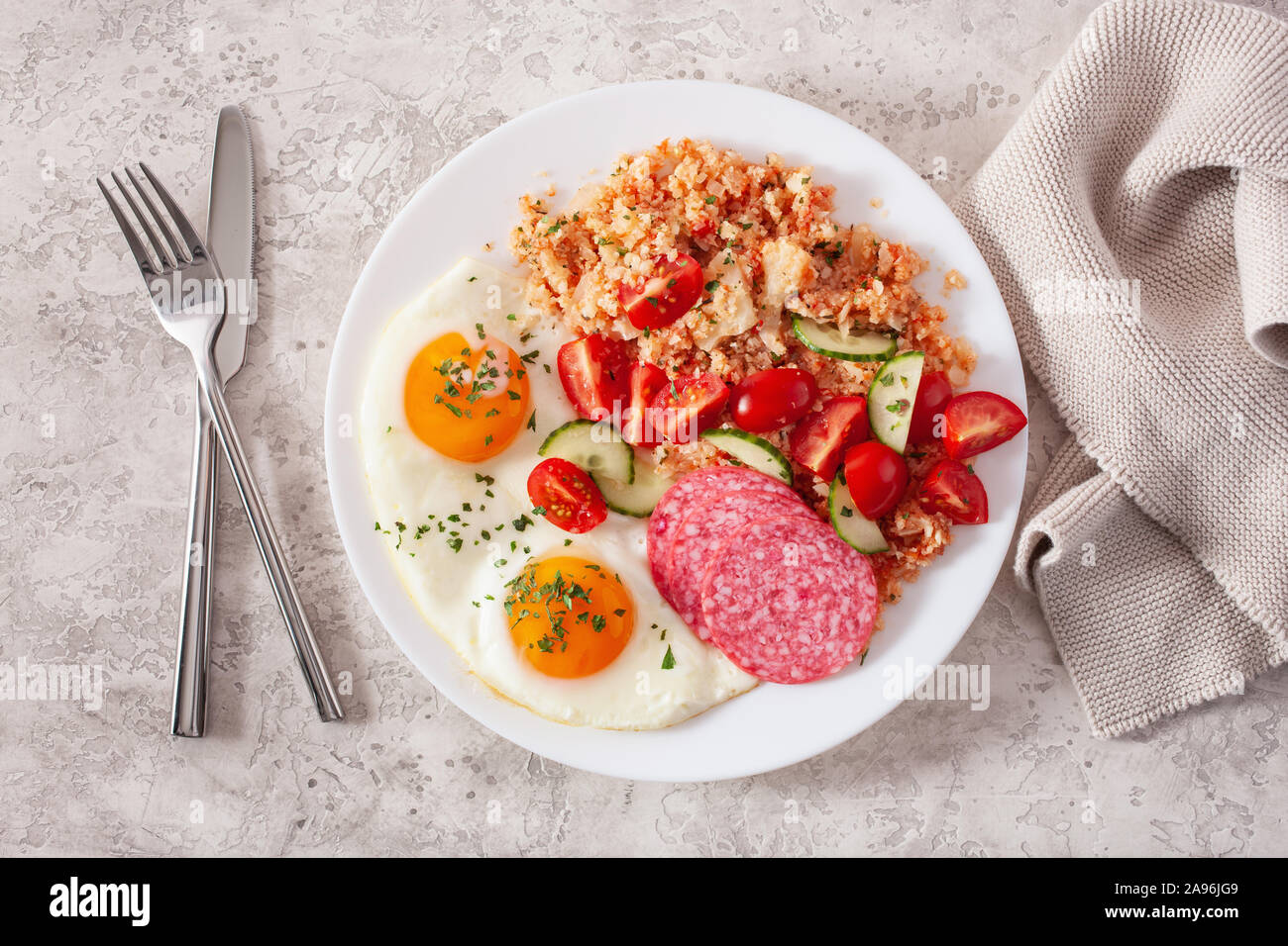 Ketogenic paleo Diät Frühstück. Blumenkohl, Reis, Spiegelei Salami Stockfoto