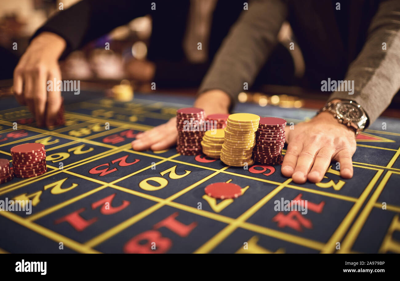 Die Hände eines Mannes Chips auf dem Tisch in einem Casino. Stockfoto