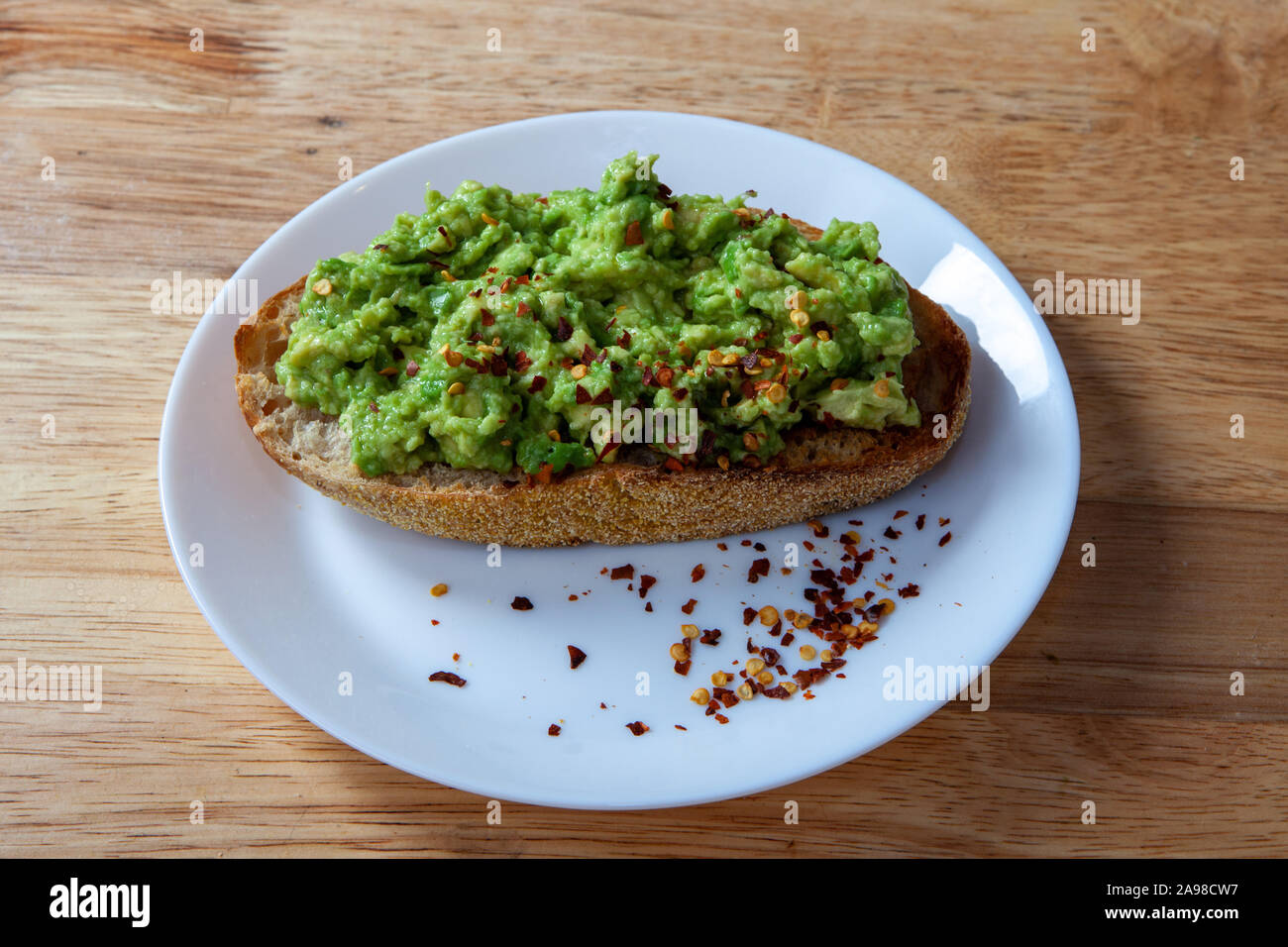 Avocado Toast mit rotem Pfeffer Flocken Stockfoto