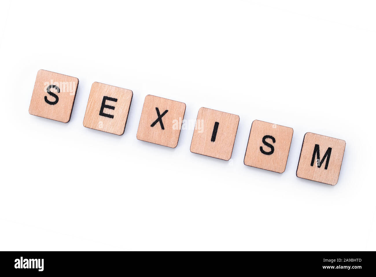 Das Wort Sexismus, Dinkel mit hölzernen Buchstabensteine über einem weißen Hintergrund. Stockfoto