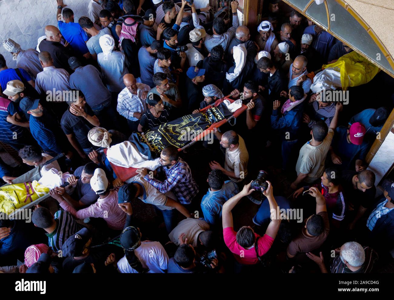(EDITOR'S NOTE: Bild zeigt Tod) Palästinensische trauernde durchführen, die Körper von Rasmi Abu Malhous und sieben Mitglieder seiner Familie während der Trauerfeier in einer Moschee in Deir al-Balah, zentralen Gazastreifen. Die Verstorbenen wurden in einer Nacht israelischen Raketenangriff, dass Ihr Haus gezielt getötet. Stockfoto