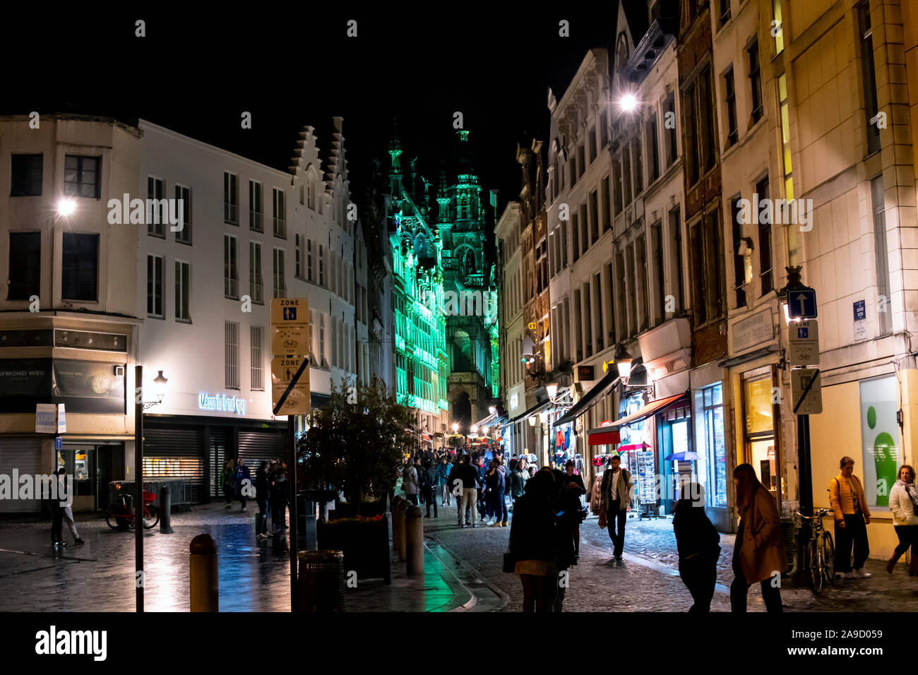 Touristen und Belgier genießen Sie eine Nacht im Zentrum der Stadt auf dem Weg, die Grand Place, beleuchtet in Grün leuchten in Brüssel, Belgien Stockfoto