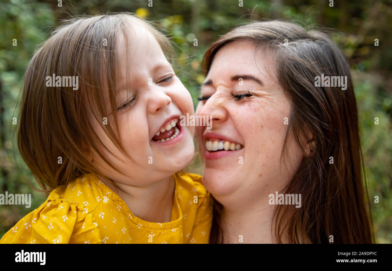Mama kitzeln Tochter und beide lachen Stockfoto