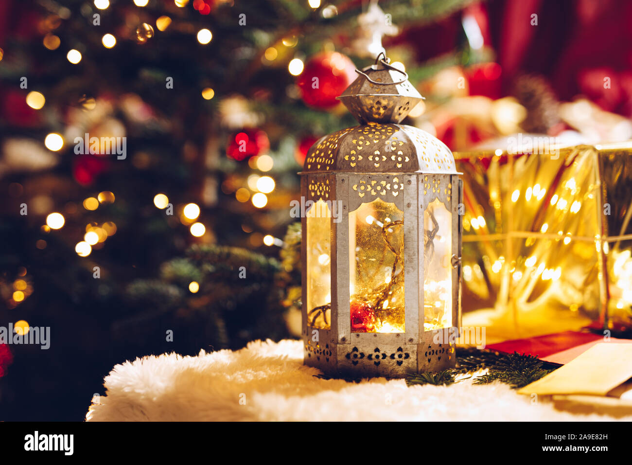 Traditionelle Europäische Weihnachten Kerze vor der eingepackten Geschenke. Vintage Bild der Weihnachtszeit im europäischen Landhausstil. Stockfoto