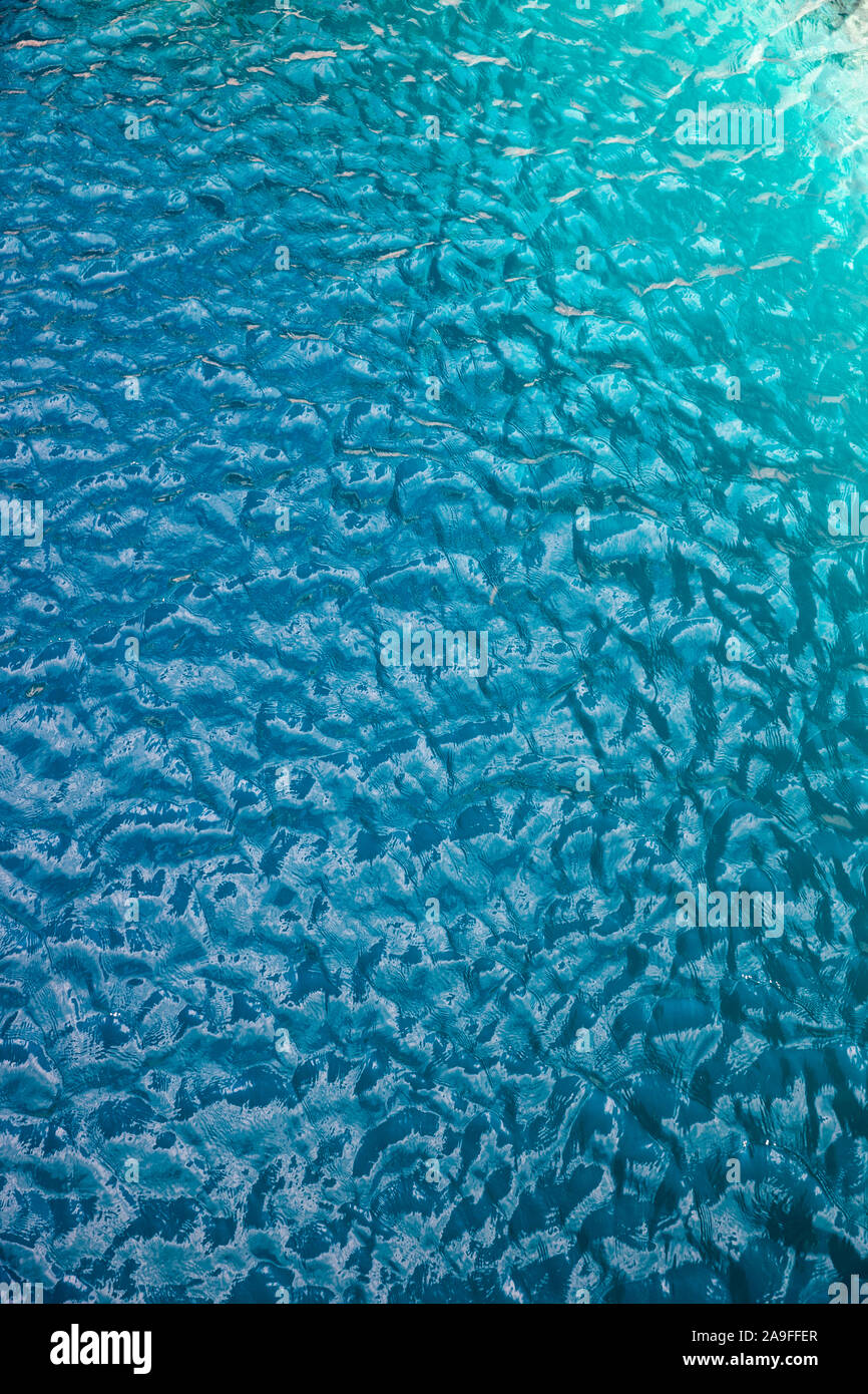 Türkisblaues Wasser Oberfläche mit kleinen Wellen Hintergrund Stockfoto