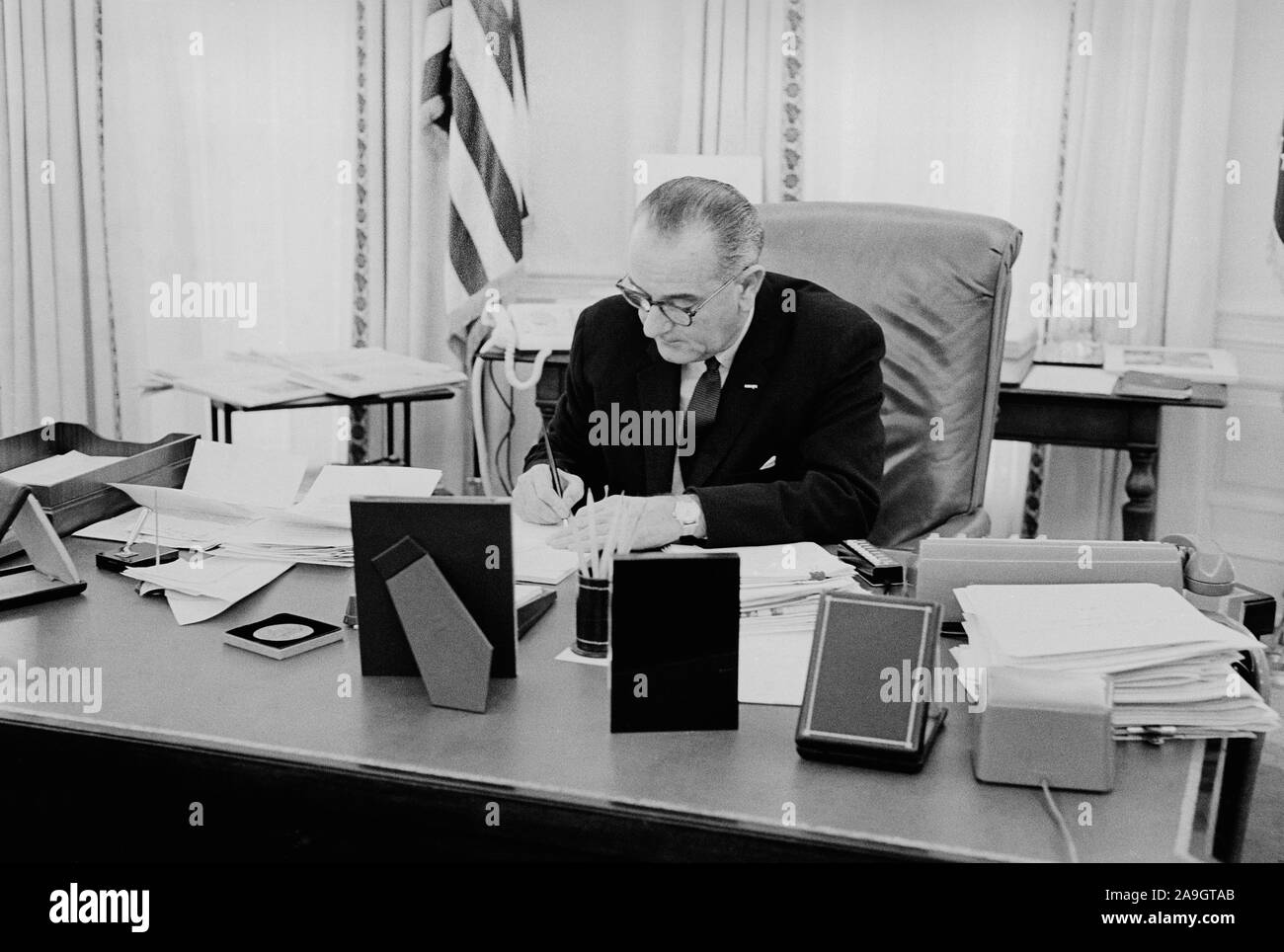 Us-Präsident Lyndon Johnson am Schreibtisch im Oval Office im Weißen Haus, Washington, D.C., USA, Foto: Thomas J. O'Halloran, Februar 1964 Stockfoto