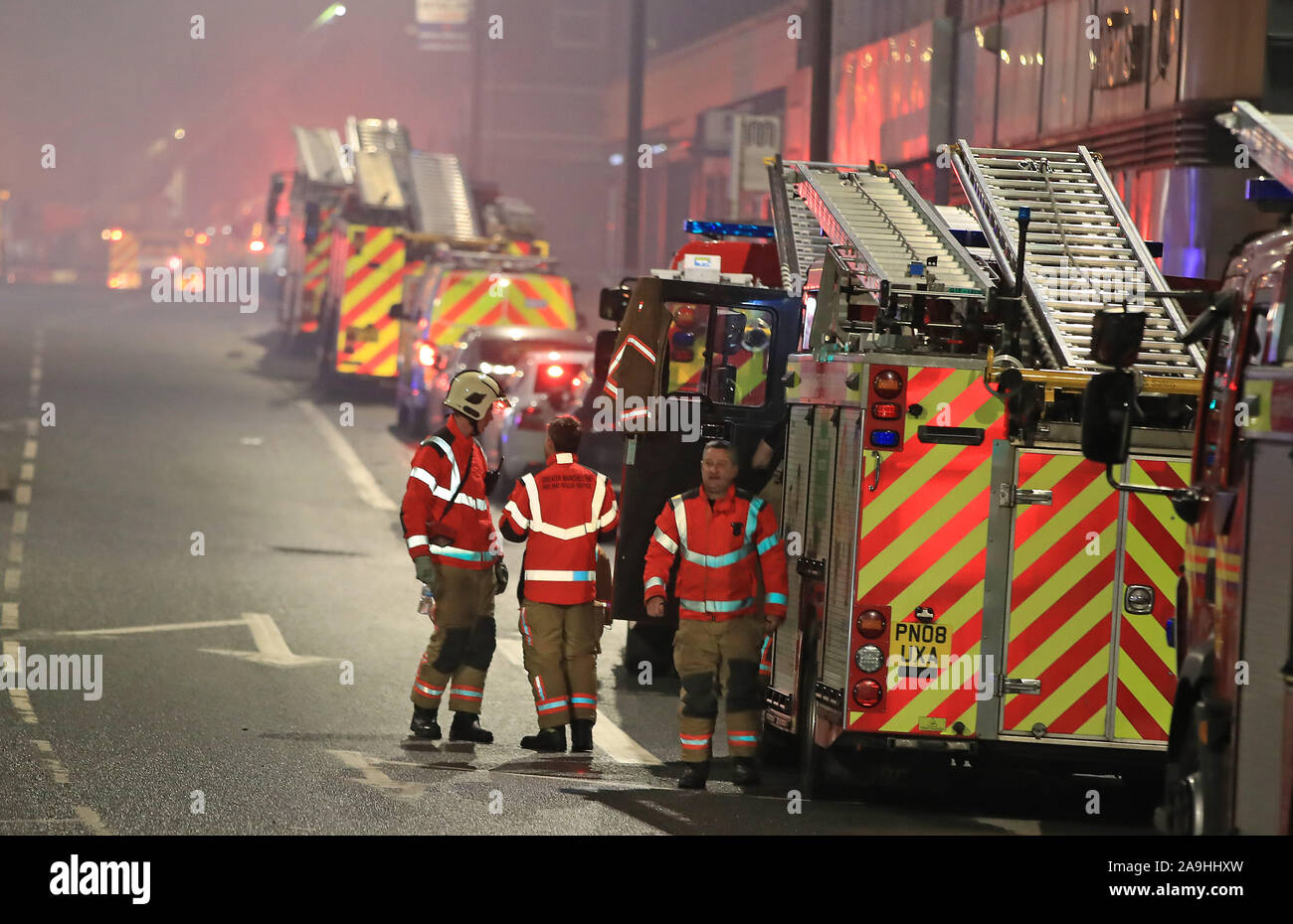 Die feuerwehrleute an der Szene nach einem Brand in den oberen Etagen eines Gebäudes auf Bradshawgate in Bolton. Stockfoto