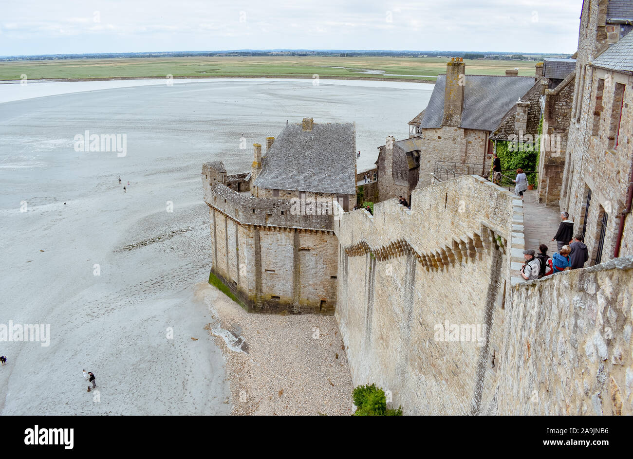 MONT SAINT-MICHEL, Frankreich - Juli 3, 2017: Touristen den Blick auf die Bucht genießen Sie von einem der Stadtmauern. Mont Saint-Michel, eine der wichtigsten Stockfoto