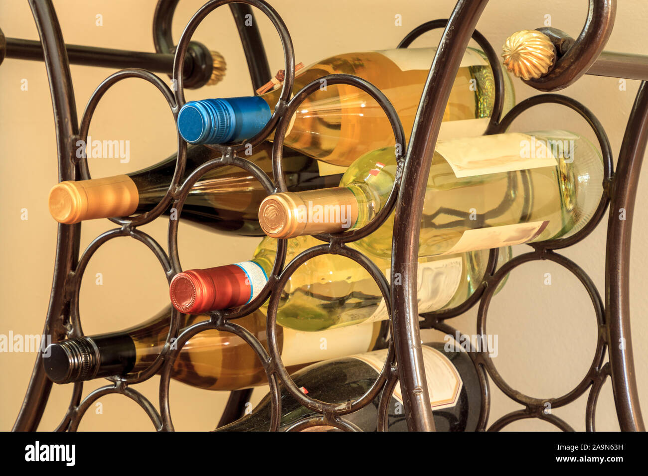 Wine Rack mit einer Vielzahl von roten und weißen Weinen in einem Stab Eisen Gruppe von Kreisen. Stockfoto