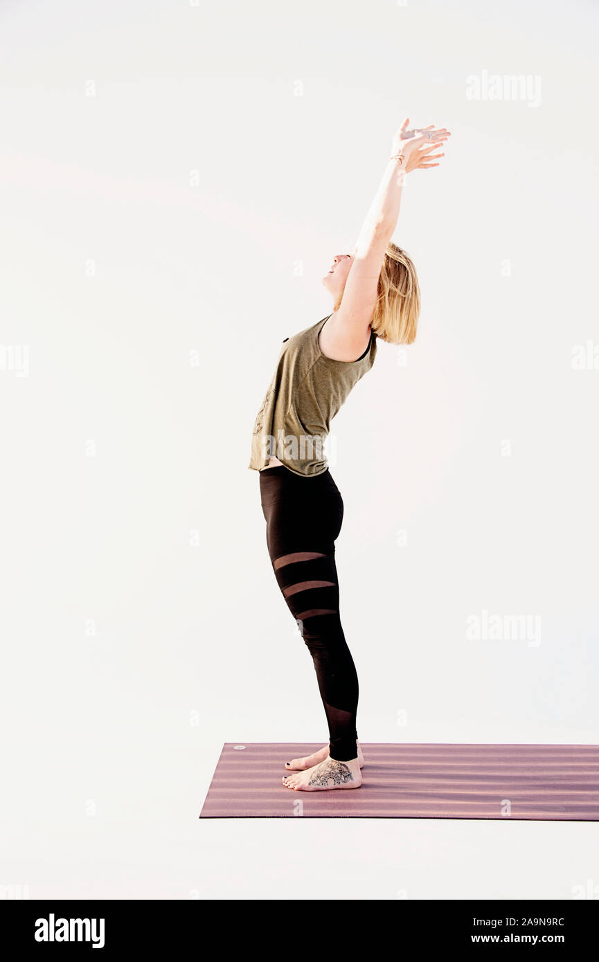 Frau Yoga Asana auf einem weißen Hintergrund. Sanfte ständigen Backbend. Stockfoto