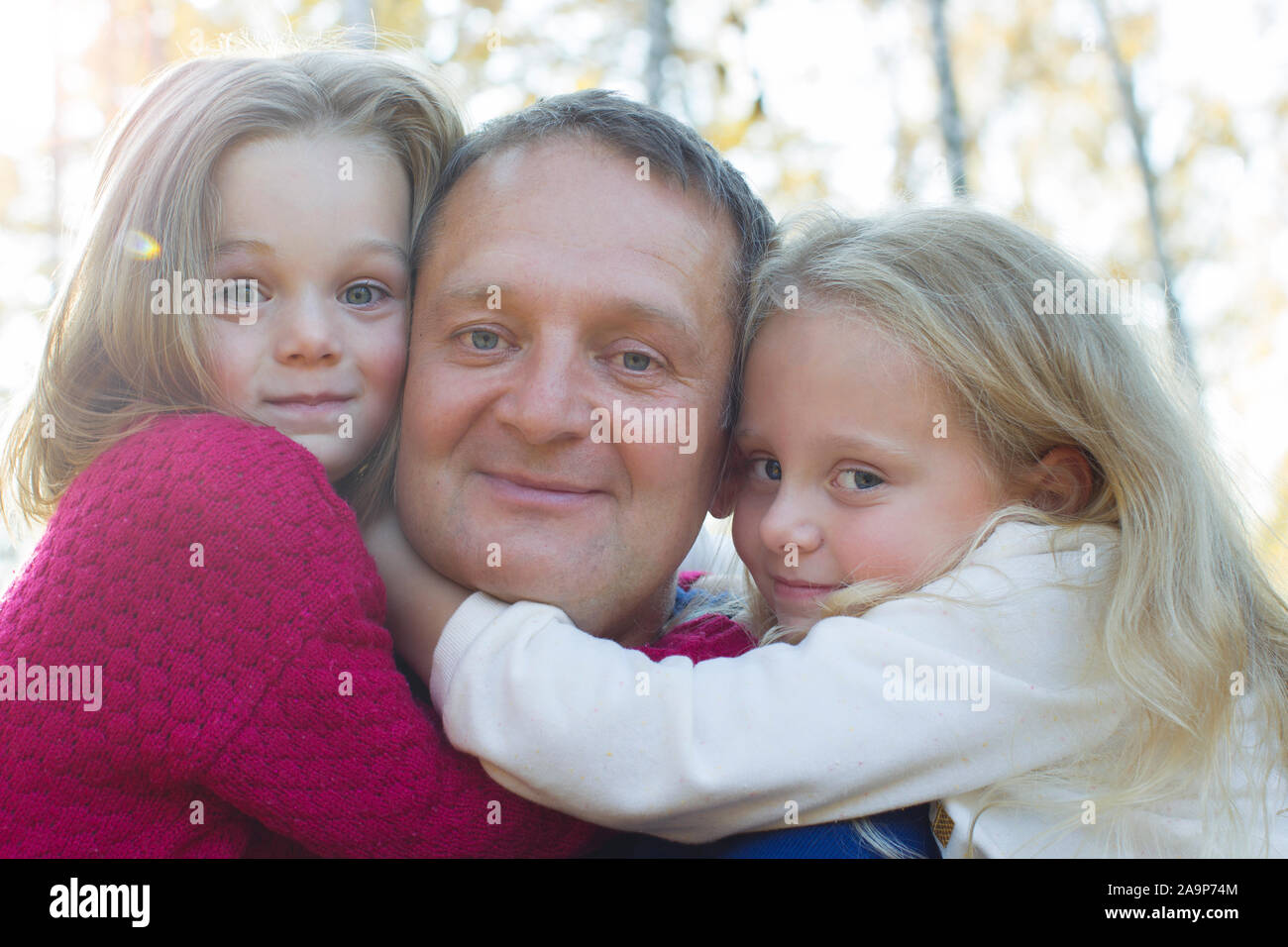 Vati mit Töchtern in der Nähe umarmen - oben Stockfoto