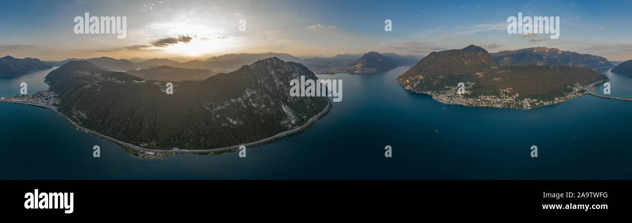 Antenne drone Shot panorama Blick auf den Luganersee, Monte Bre, Salvatore, Brücke diga di Melide und Schweizer Grenze zu Italien Stockfoto