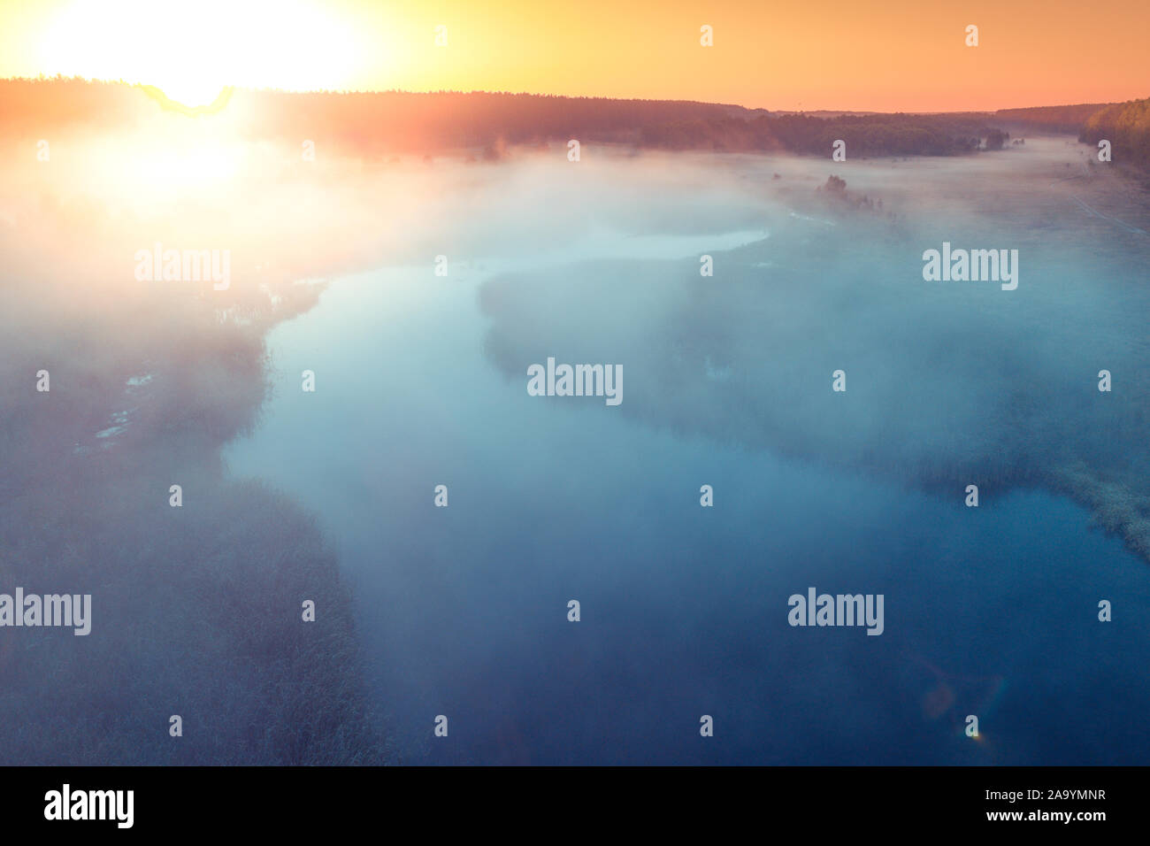 Early Misty Morning. Sonnenaufgang über dem See. Ländliche Landschaft im Sommer. Luftaufnahme Stockfoto