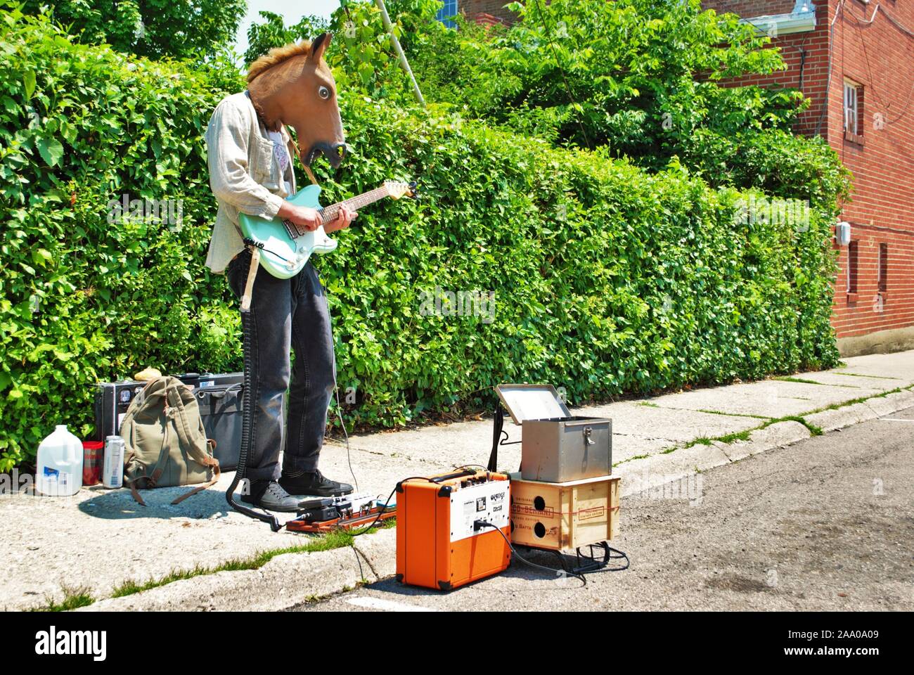 Street Performer spielen eine elektrische Gitarre beim Tragen ein Pferd Kopf Maske Stockfoto