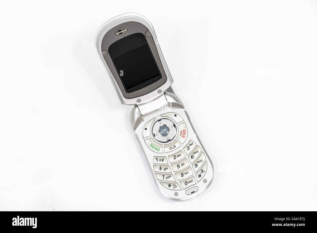 Süße kleine alte Flip style Handy mit weißem Hintergrund. Stockfoto