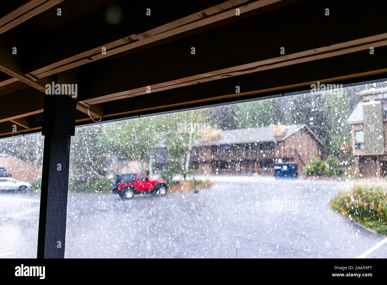 Regentag in der Wohnung Eigentumswohnung komplexe Gebäude mit Regenwasser außerhalb fallen und Vordergrund der gedeckten Dach unter Balkon Stockfoto