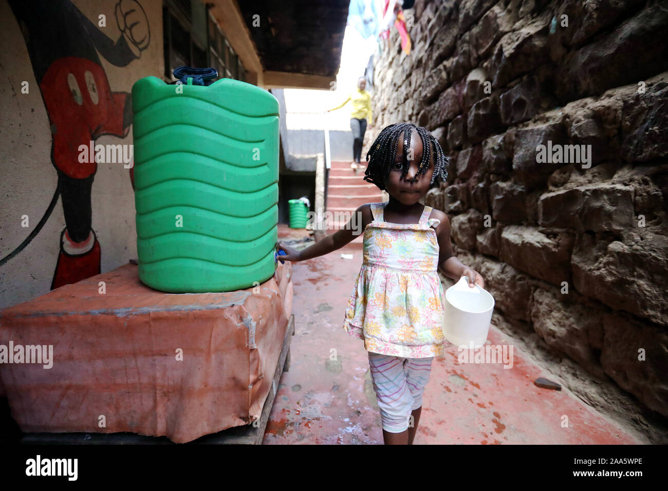 Nairobi, Kenia. Nov, 2019 19. Ein Kind zieht Wasser aus einem Eimer am Emmanuel neue Hoffnung Waisenhaus in Nairobi, Kenia, am 19.11.2019. Die emmanuel neue Hoffnung Waisenhaus in Soweto Slum in Nairobi. Nach seinem Gründer, Wanjiru Banis, 43 Kinder bisher verabschiedet wurden. Credit: Wang Teng/Xinhua/Alamy leben Nachrichten Stockfoto