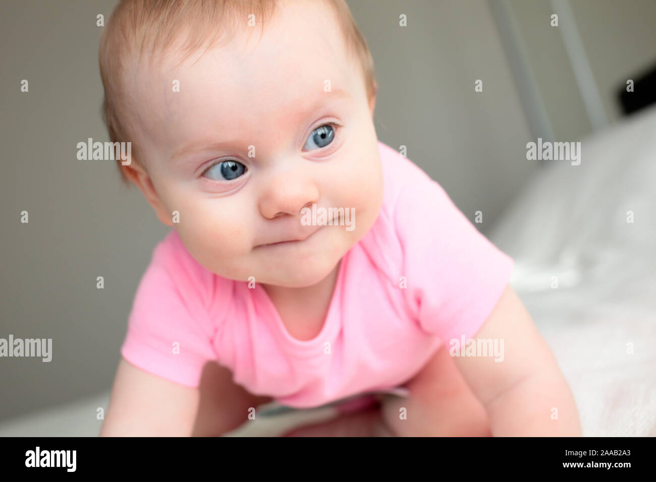 Close up Portrait von Süßen 8 Monate alten Baby Girl mit großen blauen Augen, Happy Baby Girl Stockfoto