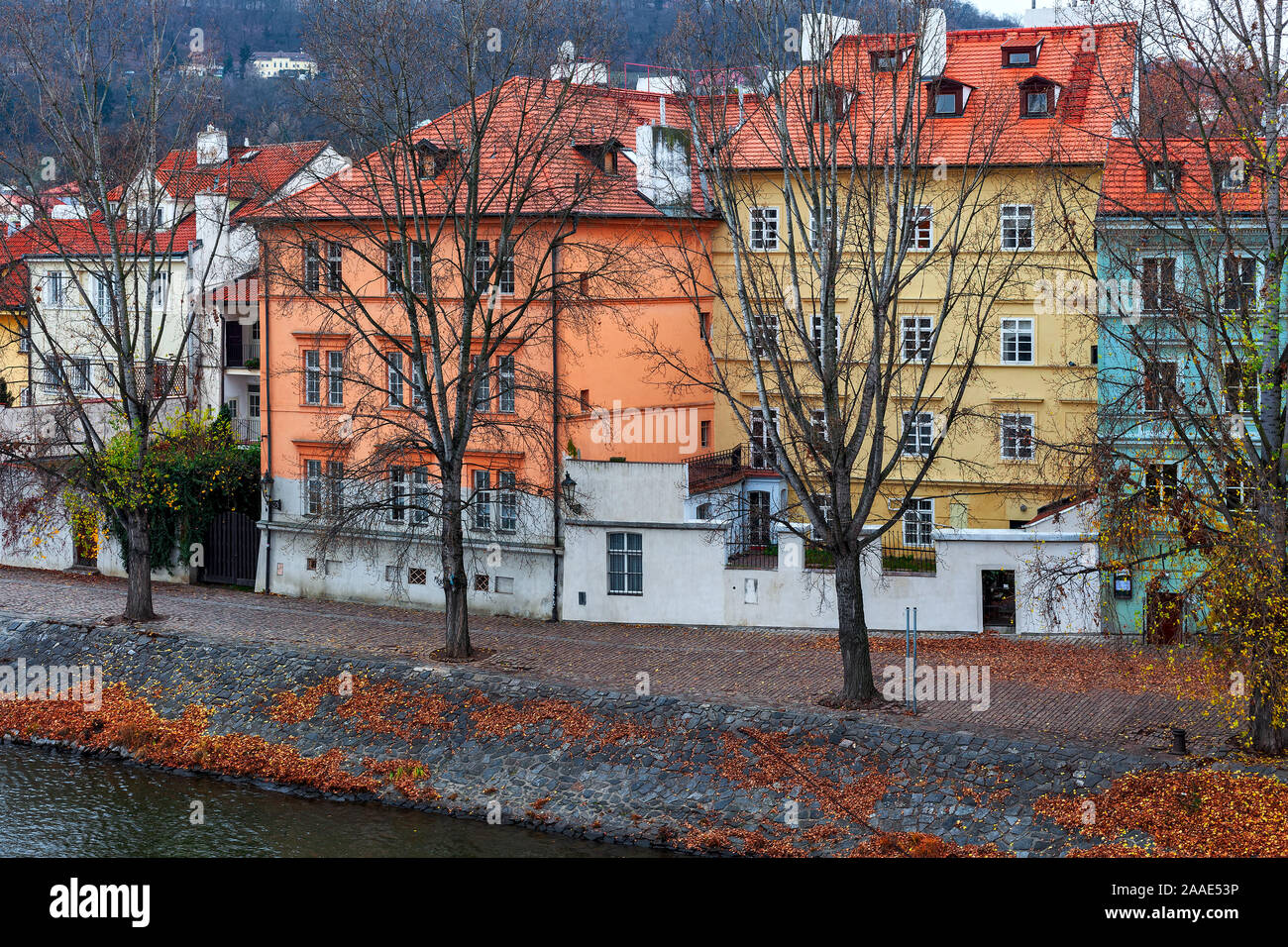 Blick auf die bunten Häuser mit roten Dächern am Ufer des Flusses Moldau in der Altstadt von Prag im Winter. Stockfoto