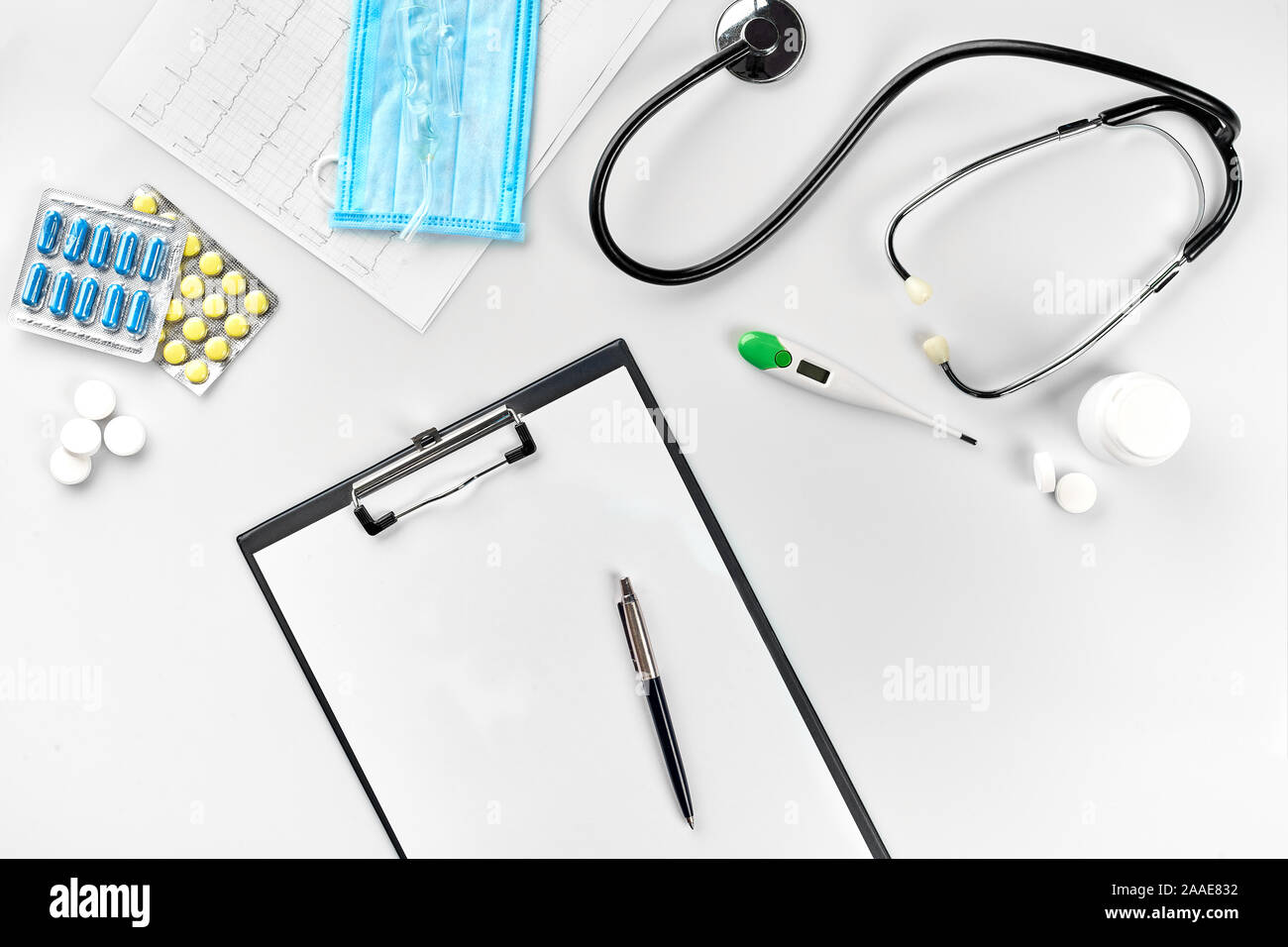 Geschäft für Krankenhaus: Pillen, Stethoskop, medizinische Geräte, Notizbuch mit Stift und Maske auf weißem Hintergrund. Der moderne Doktor in der Tabelle festgelegt. Stockfoto