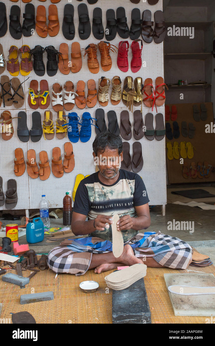 Ein Schuhhersteller, die Schuhe zu einem Straßenrand shop in Mahabalipuram (Indien Stockfoto
