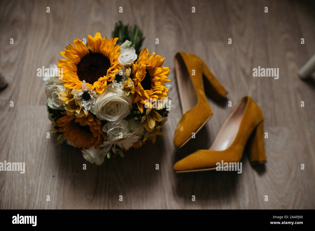 Foto von Hochzeitsbouquet und Schuhen von oben auf dem Boden. Stockfoto