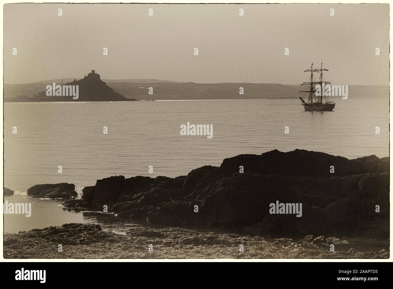 Die brig 'Astrid' vor Anker in Mount's Bay aus Penzance, Cornwall, UK: St. Michael's Mount darüber hinaus. Antikes aussehen: sepia-getönten und mit groben Grenzen Stockfoto