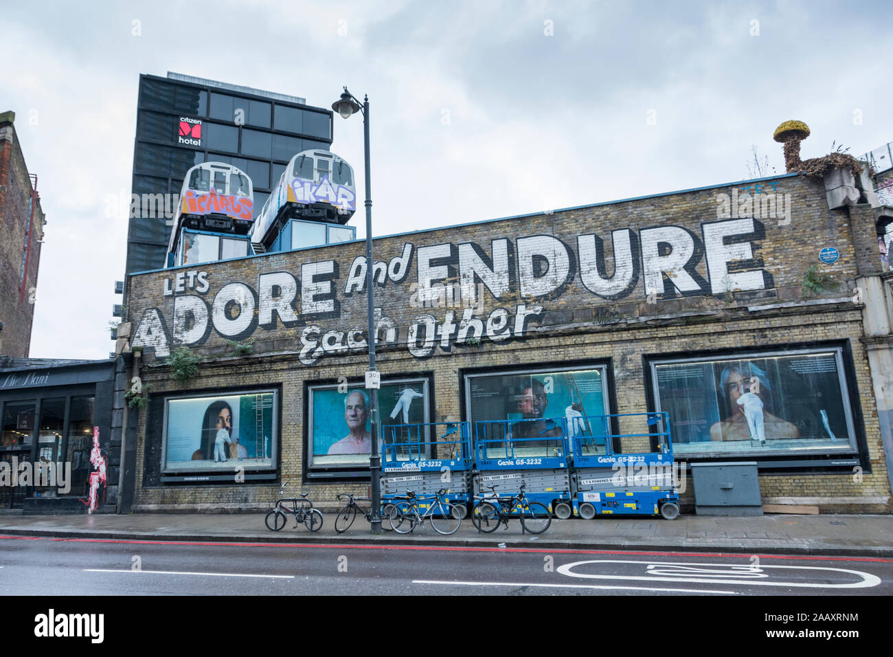 Die verehren und Ertragen, Einander street art von Stephen Powers auf Great Eastern Street, London, UK lassen Stockfoto