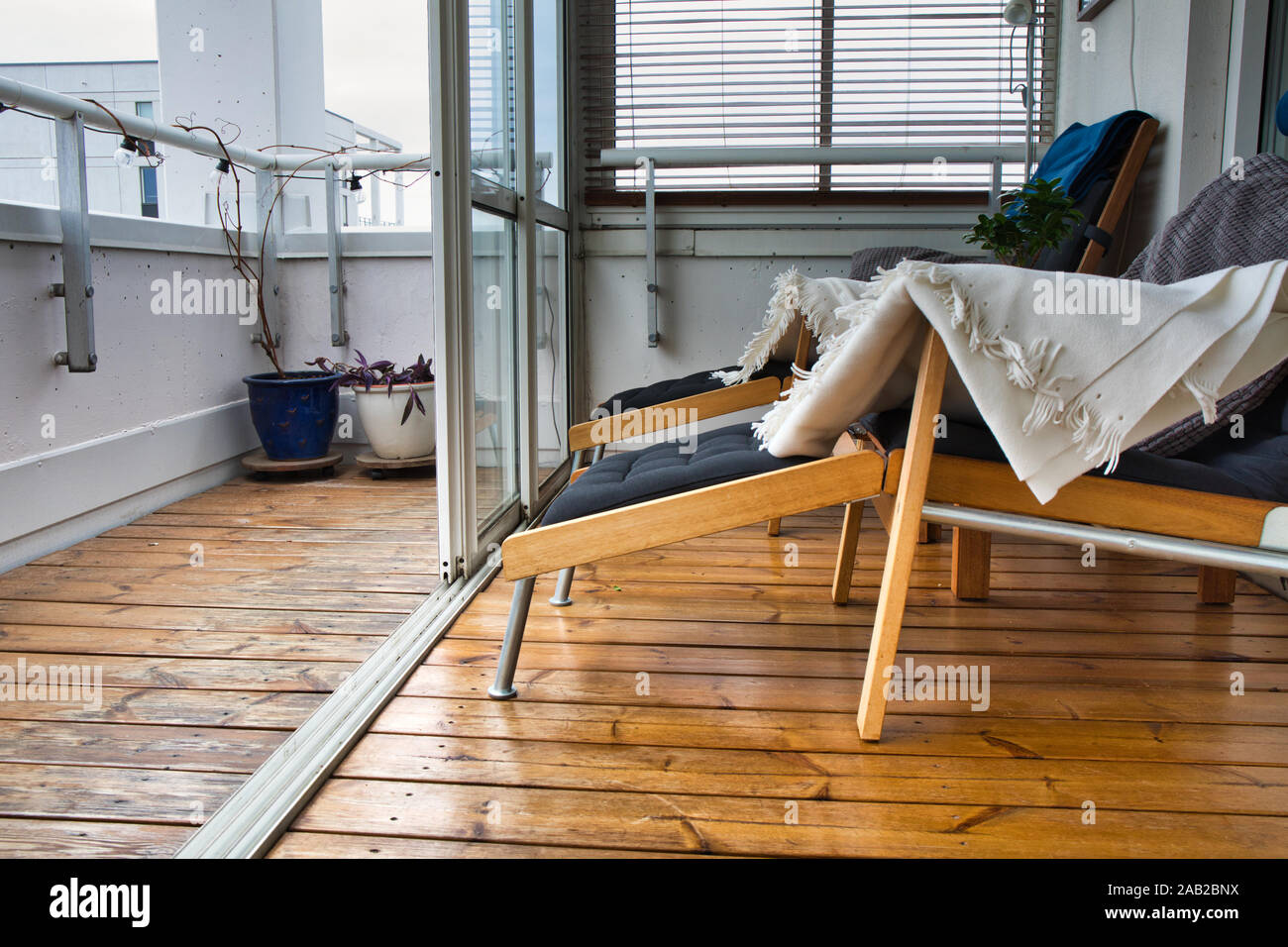 Liegestühle auf der Holzterrasse des Luxus hochhaus Apartment mit Glasschiebetüren, Upplands Vasby, Stockholm, Schweden Stockfoto