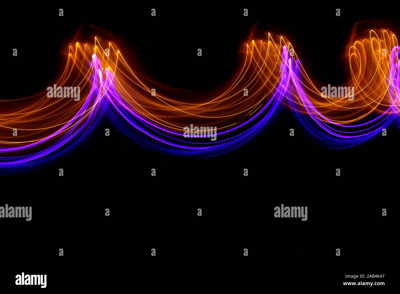 Lange Belichtung Foto von Neon gold und violett in abstrakten wirbelt, parallele Linien auf schwarzem Hintergrund. Licht Malerei Fotografie. Stockfoto