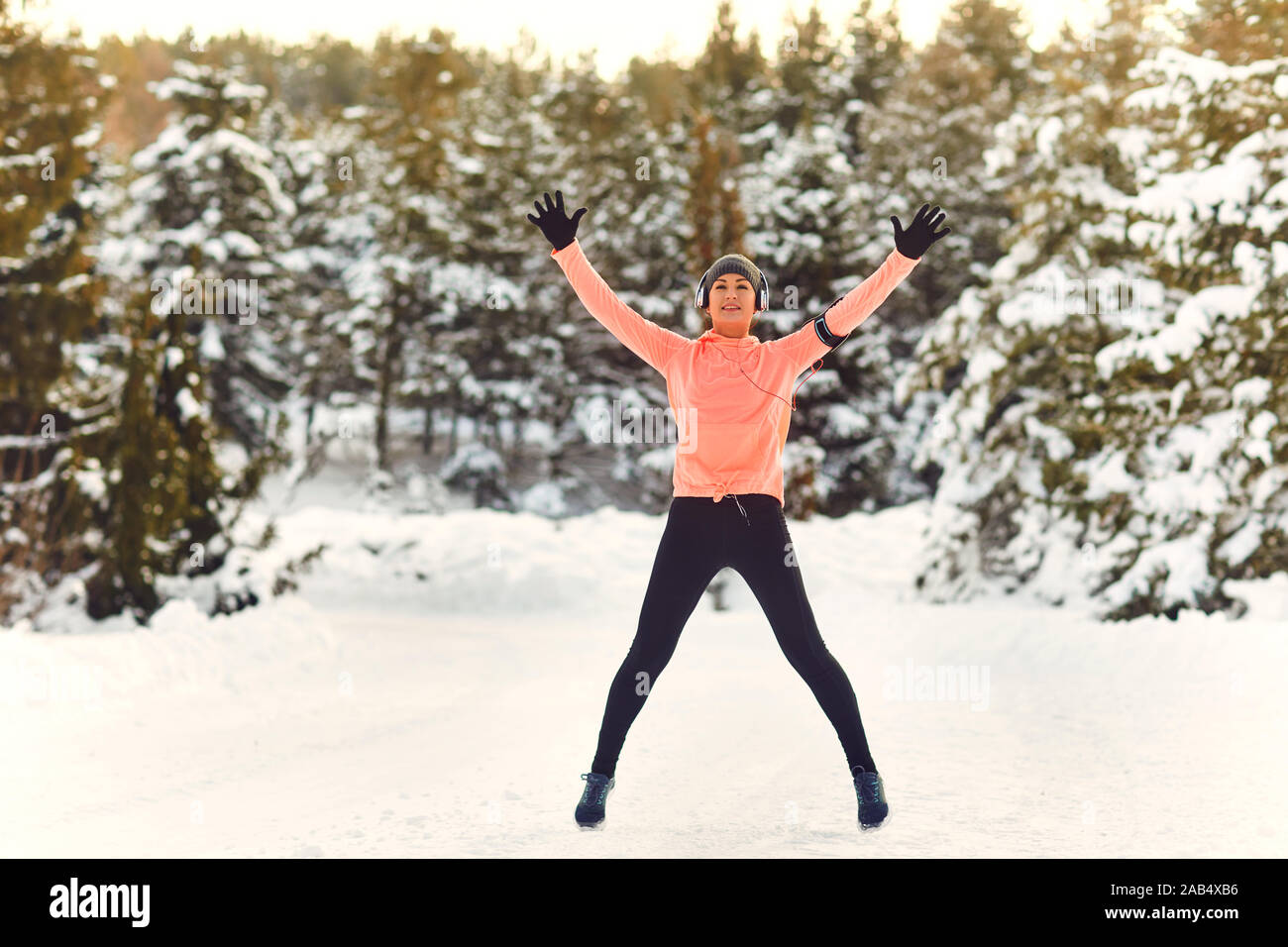 Frau hat ein Warm-up in den Schnee im Winter. Stockfoto