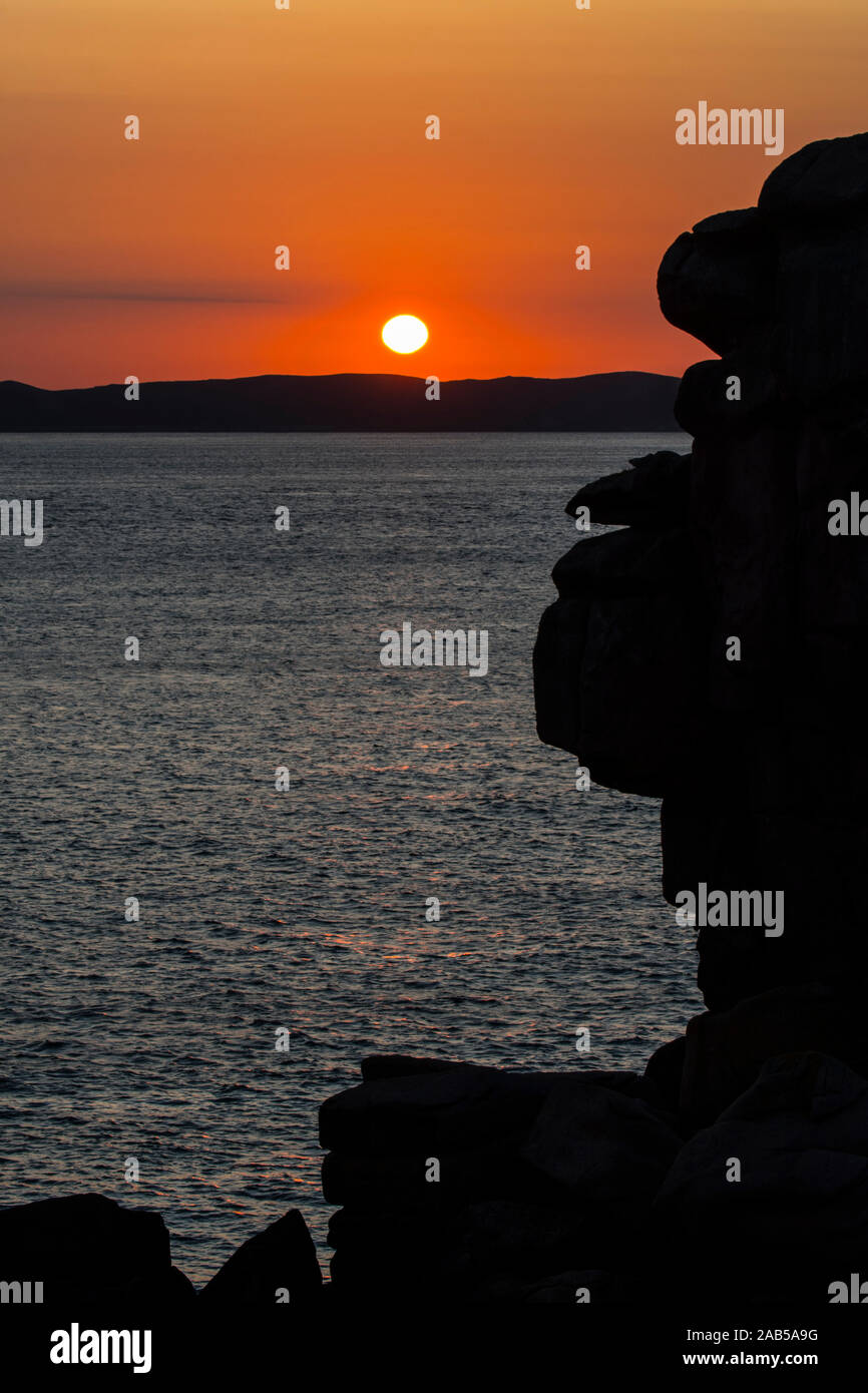 Seltsame Felsformationen Silhouette gegen Sonnenaufgang entlang der Côte de Granit rose/rosa Granit Küste, Côtes d'Armor, Bretagne, Frankreich Stockfoto