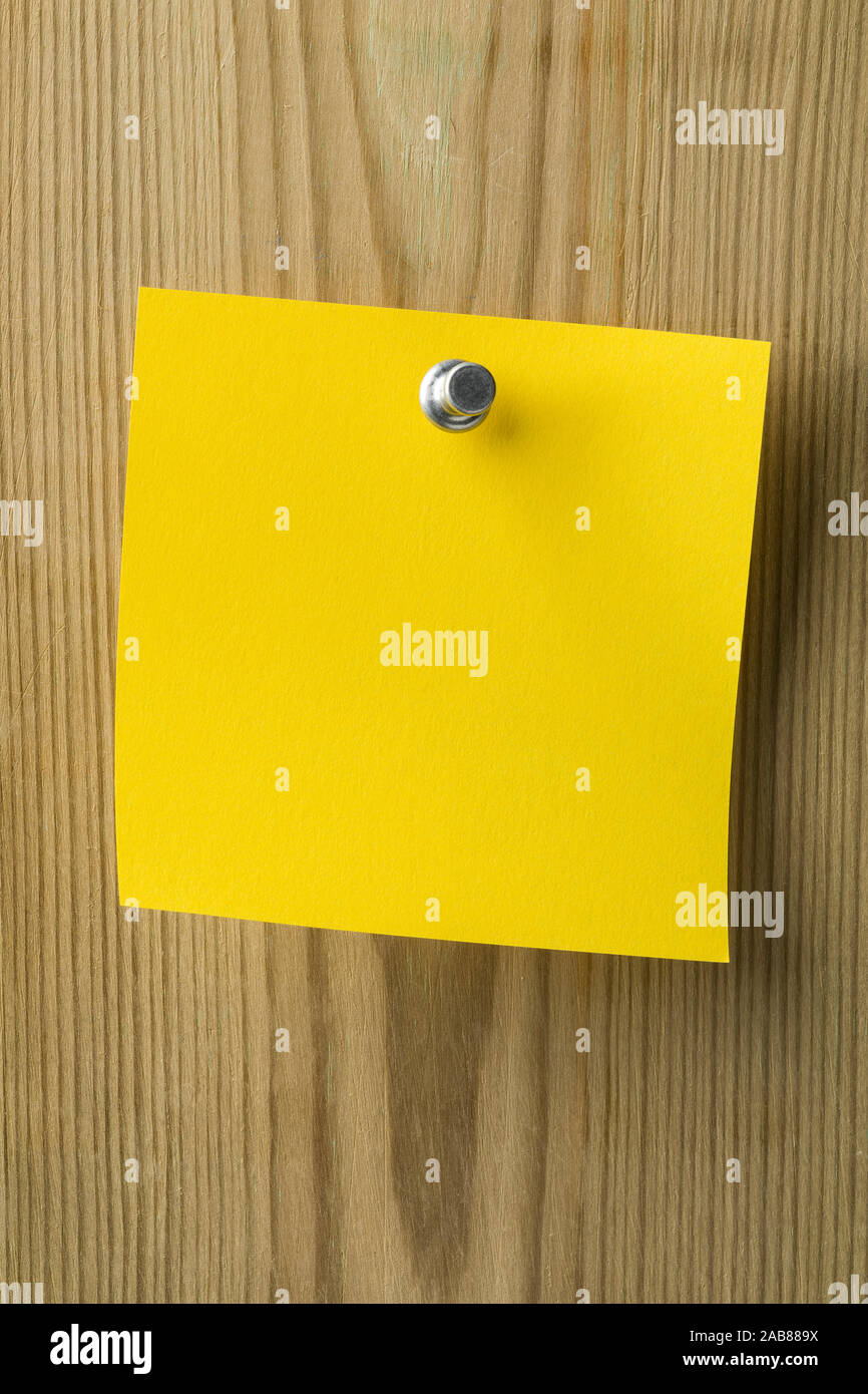 Leere gelbe Papier Post it Hinweis auf einer Holzplatte befestigt Stockfoto