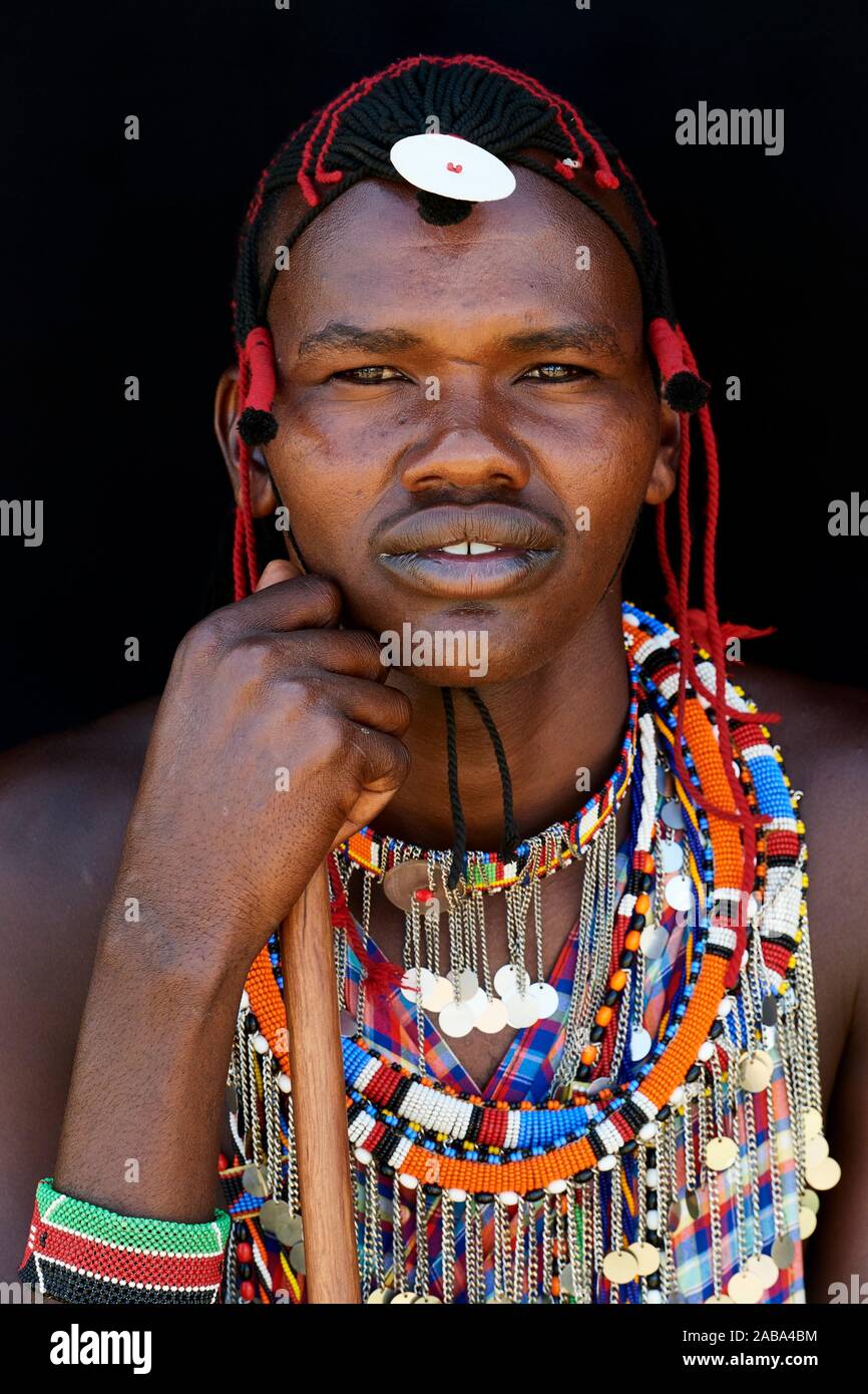 Masai Mann mit traditionellen Raupe Arbeit und Farbe Glas geschmückt Perlen um den Hals. Masai Mara National Reserve, Kenia. Stockfoto
