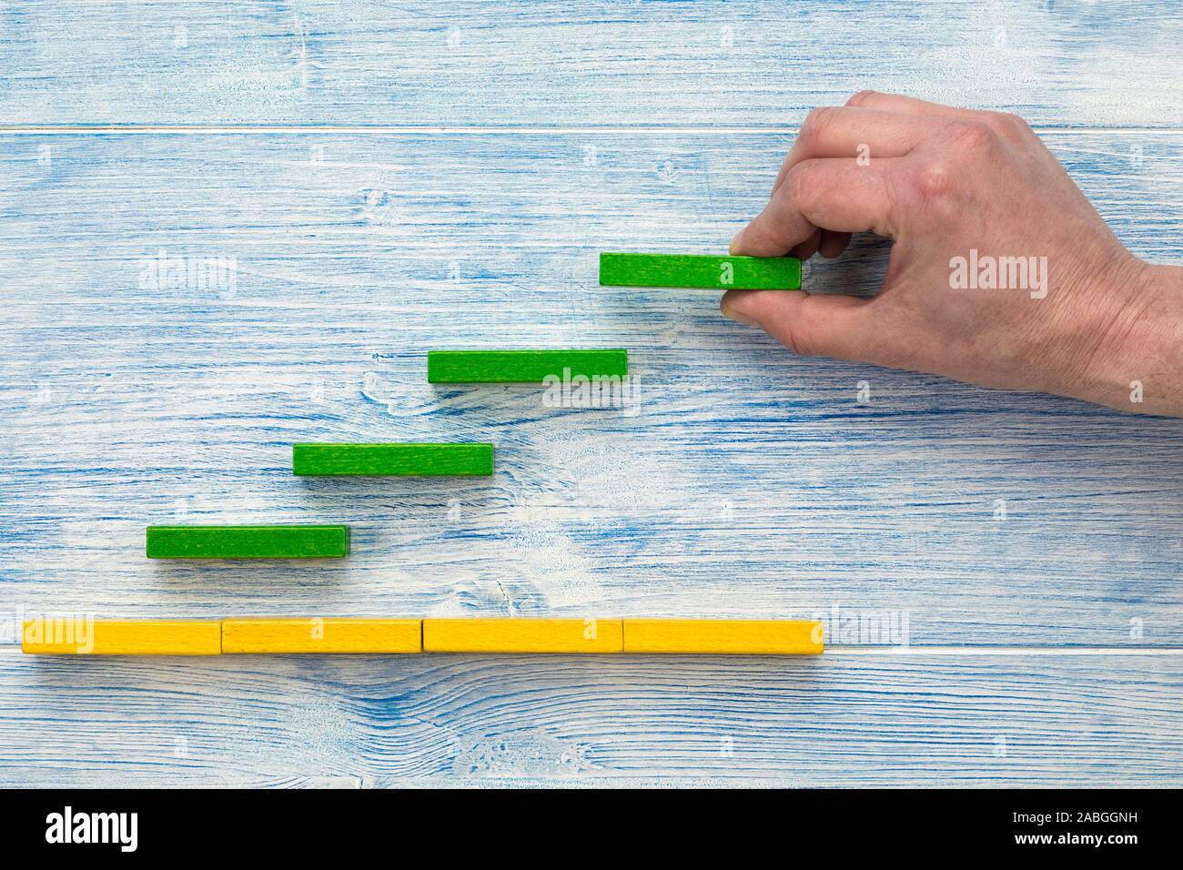 Wachstum und Erfolg Konzept. Männliche hand Organisation Bausteine als Treppenstufen. Stockfoto