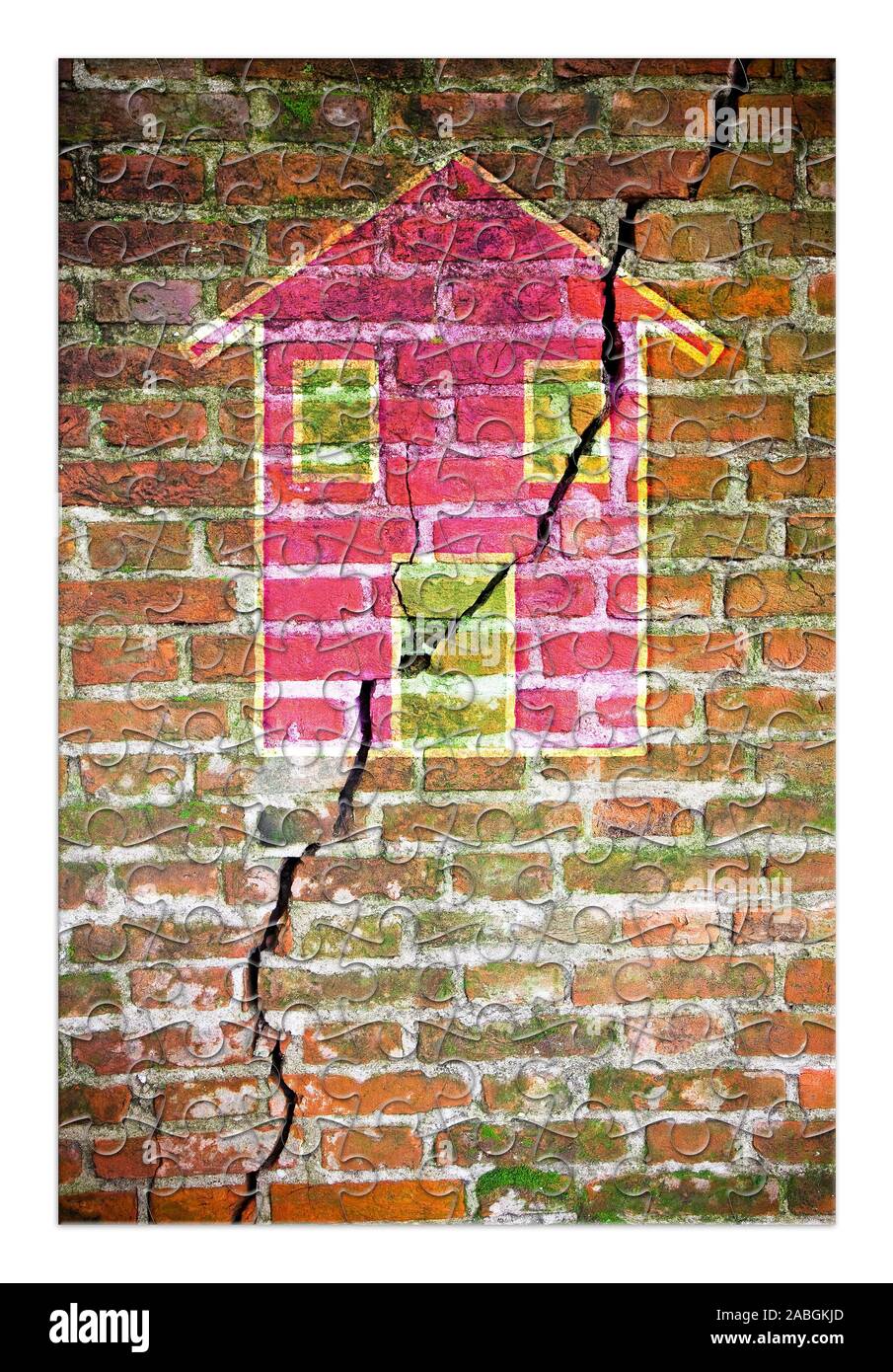 Risse im Mauerwerk mit einem farbigen Haus in Puzzle Form gezeichnet - Konzept Bild Stockfoto