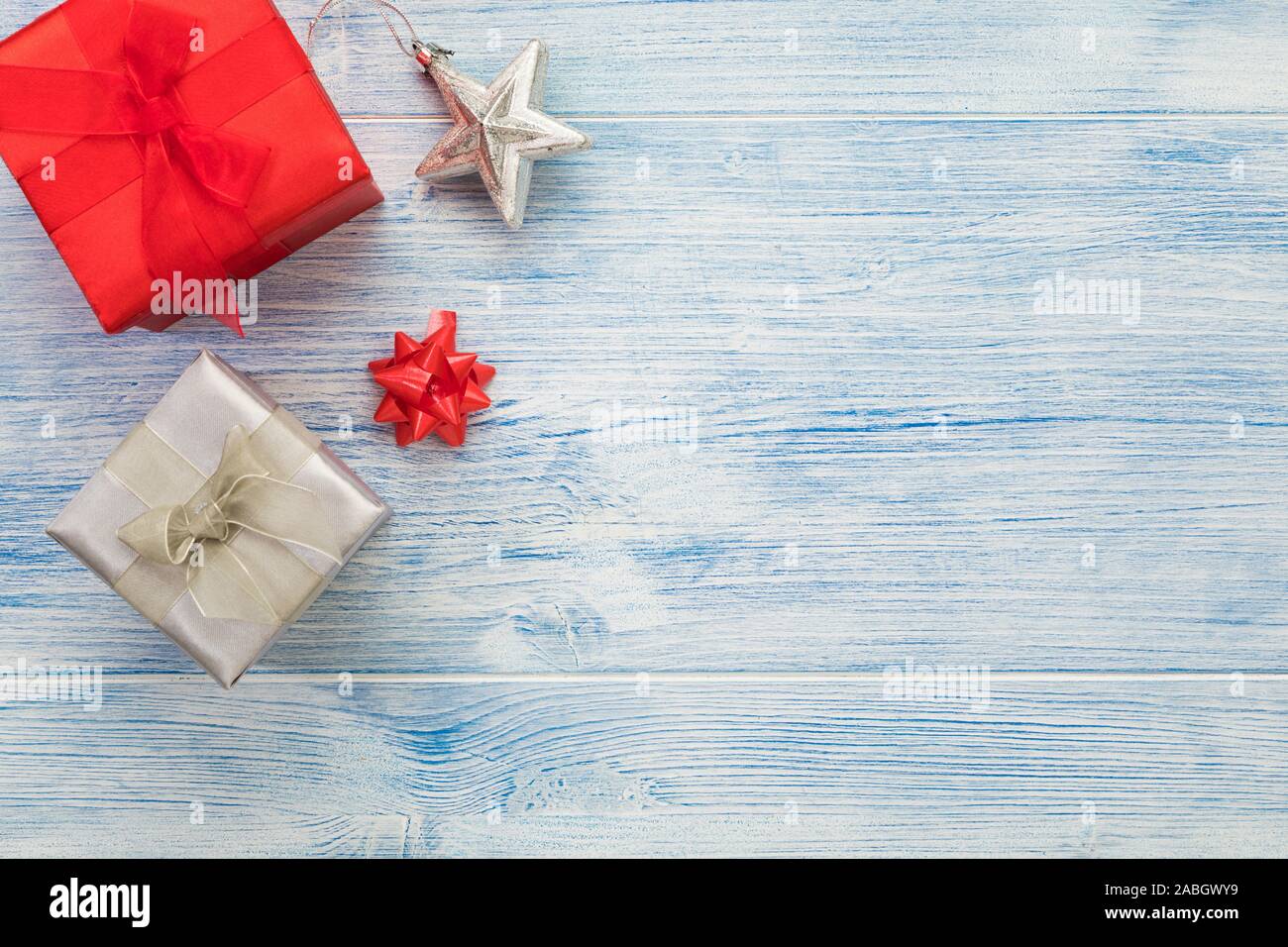 Weihnachten Hintergrund mit roten und silbernen Geschenkboxen, Farbband und Star Dekoration, große Kopie Speicherplatz auf Blau rustikalem Holz Stockfoto