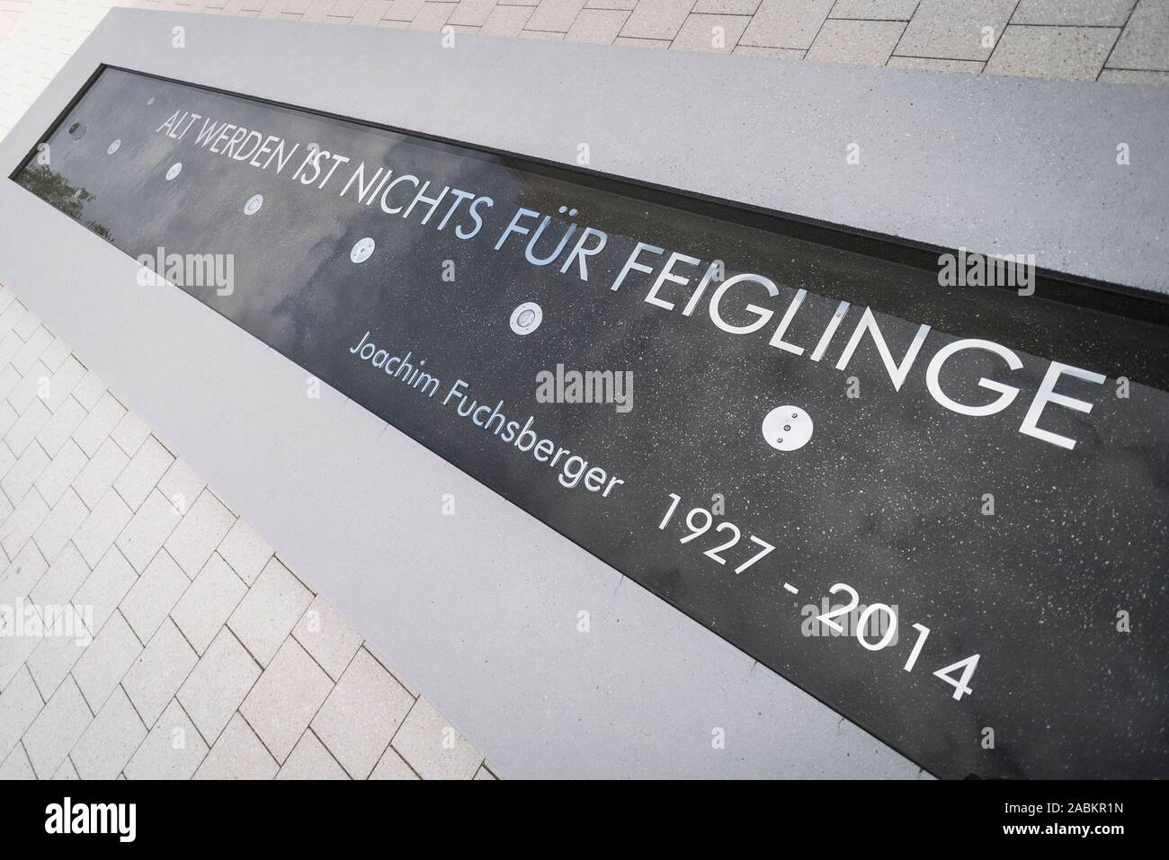 Joachim Blacky Fuchsberger das Zitat "Alt werden ist nichts für Feiglinge" steht in den Brunnen im Hof des Haus der Begegnung in Grünwald. [Automatisierte Übersetzung] Stockfoto