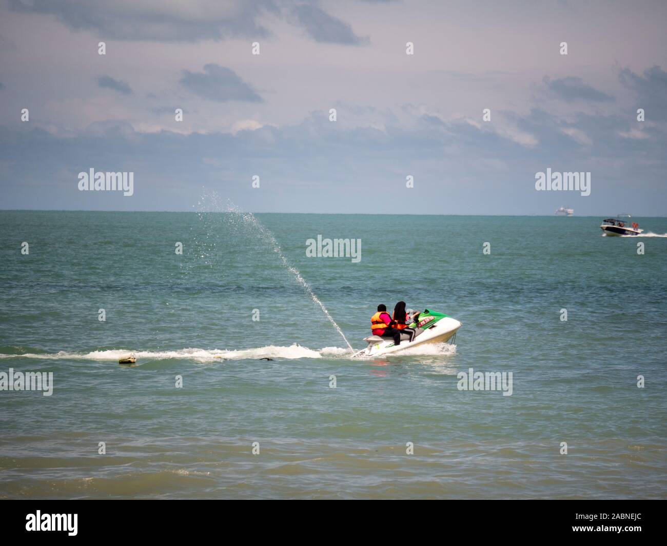 Zwei muslimische Frauen reiten Jet-ski in Batu Ferringhi Stockfoto