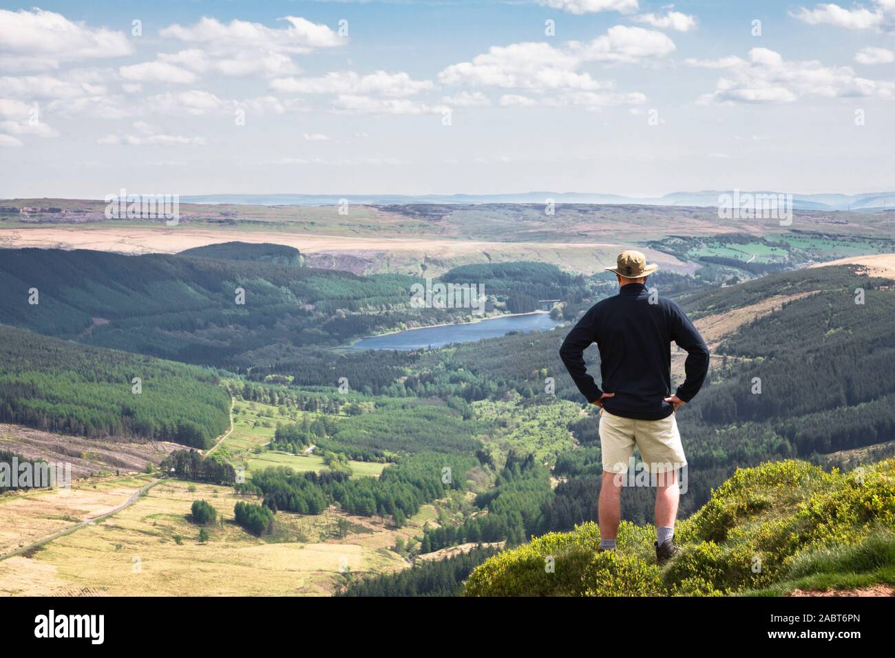 Mann, der auf einem Hügel bei einem Tal auf den Horizont schauen. Mai Konzept der Leistung oder der Erfolg zeigen. Pen Y Fan, Brecon Beacons, Wales, Großbritannien Stockfoto