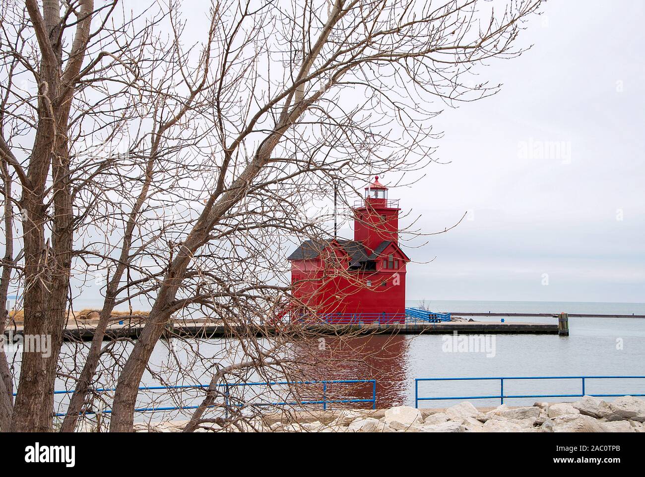 Red Michigan Lighthouse in Holland Hafen mit winter baum Stockfoto