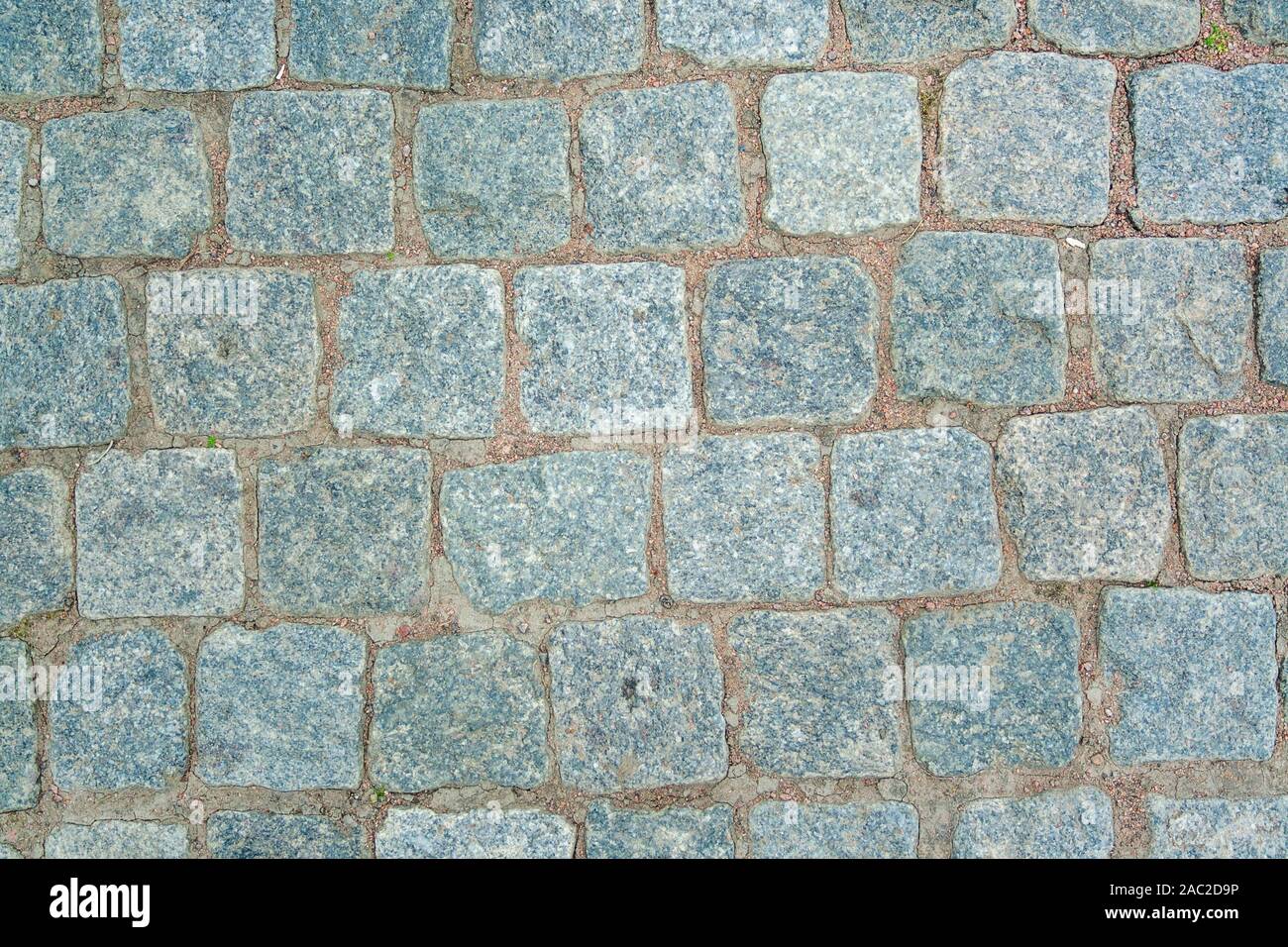 Alten Granit Pflastersteine. Textur des alten Granit Pflastersteine. Die Beschaffenheit der Fahrbahn Granit Muster Tapete für Design. Grobe Textur Stockfoto