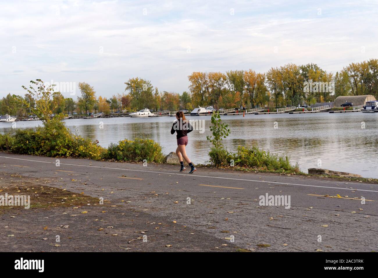 Junge Frau joggen Neben der Lachine Canal in Lachine, Montreal, Quebec, Kanada Stockfoto Junge Frau joggen Neben der Lachine Canal in Lachine, Montreal, Quebec, Kanada Stockfoto