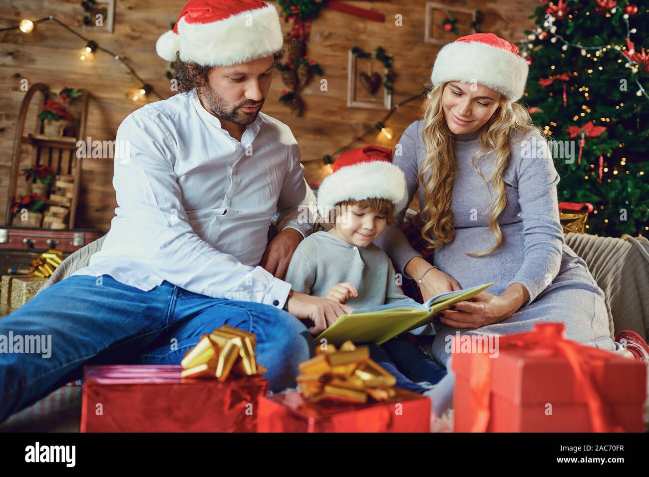 Familie mit einem Buch zu Hause in Weihnachten Stockfoto