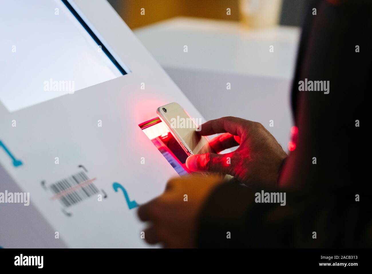 Ein Handy scannt ein QR-Code auf einem Computer in einem Kongress Stockfoto